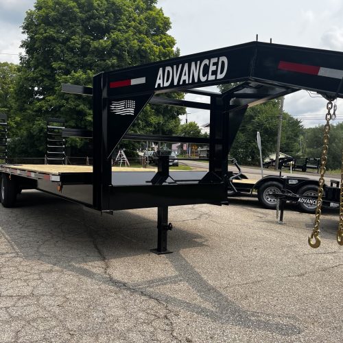 A 14k Heavy Duty Gooseneck Trailer with ADVANCED on the front is parked on cracked asphalt in Ohio. Trees and a cloudy sky are in the background, with a chain hanging from its front corner—its up for sale.