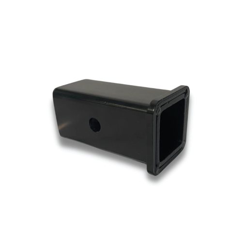 The 3 Sq. Tube Reducer is a black plastic rectangular adapter, ideal for trailer modifications in Ohio. It has a square opening and a side circular cutout, perfect for enhancing trailers. Its sleek design is highlighted against a white background.