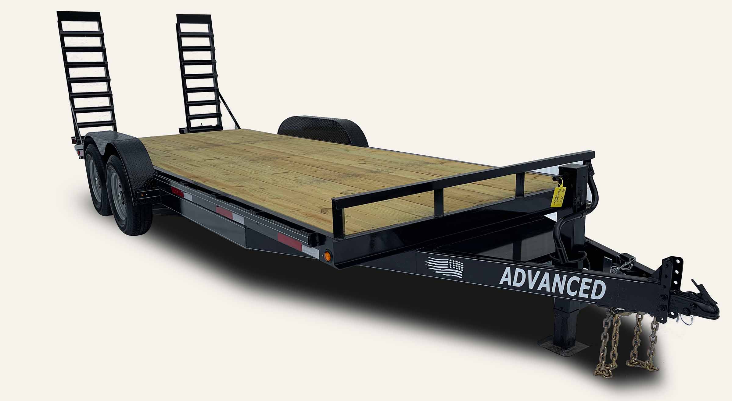 A flatbed trailer with dual ramps at the rear, two wheels on each side, and a wooden deck. The front boasts a hitch and chains for towing. With ADVANCED printed on the side in white letters, this is among the top equipment trailers for sale. A flatbed trailer with dual ramps at the rear, two wheels on each side, and a wooden deck. The front boasts a hitch and chains for towing. With ADVANCED printed on the side in white letters, this is among the top equipment trailers for sale.